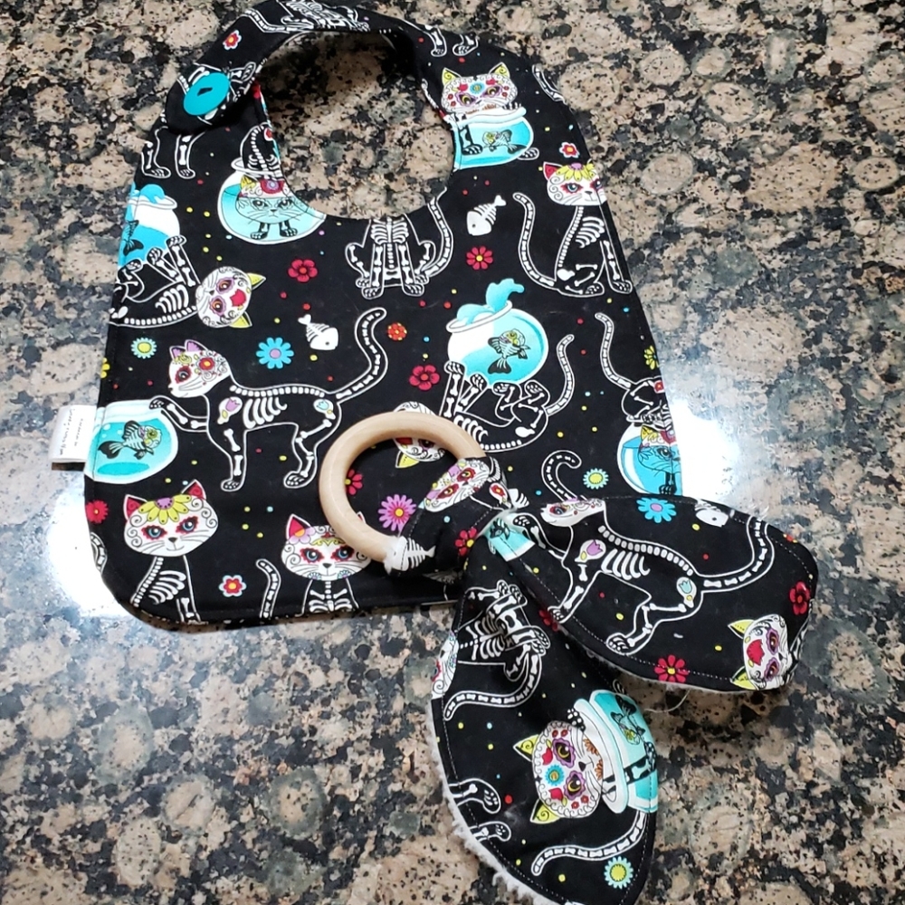 Baby bib and bunny ear teether set.